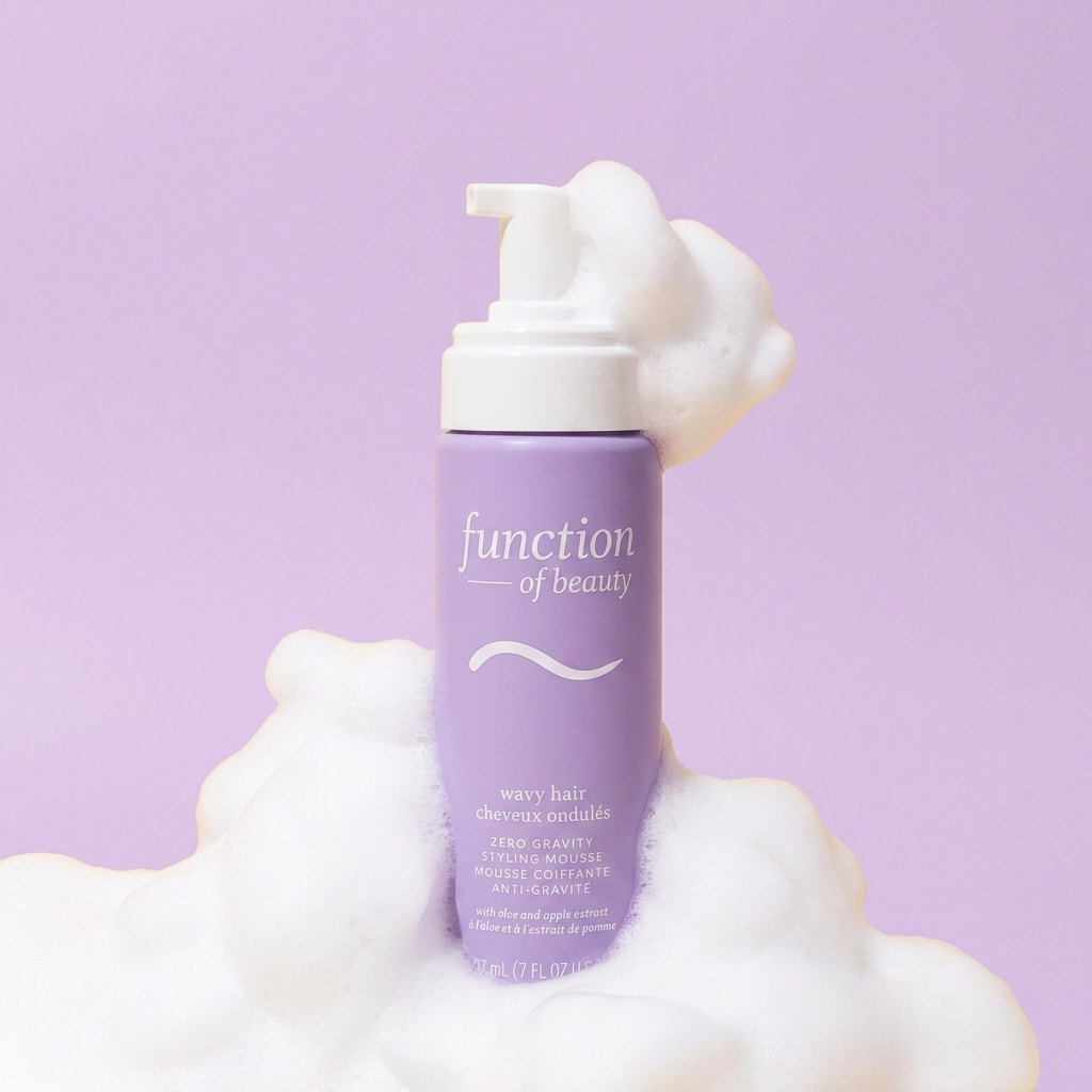 Lilac foaming bottle sitting on a cloud of white foam